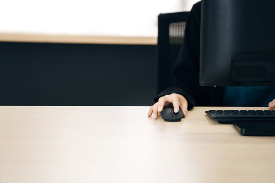 Business hand asian woman salary using mouse and computer.