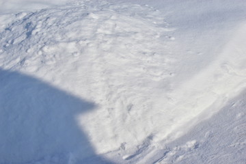 Piles of snow and wooden boxes with a tree trunk