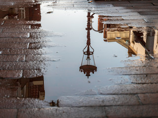 Amsterdam Streetlamp in water reflection wet spot