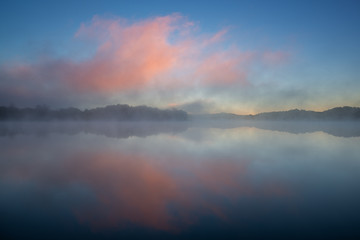 Landscape at dawn of Whitford Lake in fog, Fort Custer State Park, Michigan, USA
