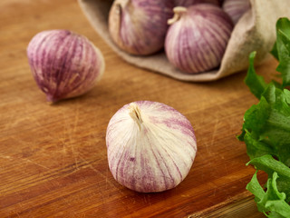 Fresh garlic on market table closeup photo. Vitamin healthy food spice image. Spicy cooking ingredient picture.