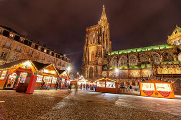 Fototapeta na wymiar Long exposure photography of Christmas Market near Cathedral in the city of Strasbourg at night, Alsace region, France