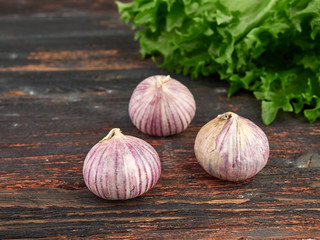 Fresh garlic on market table closeup photo. Vitamin healthy food spice image. Spicy cooking ingredient picture.
