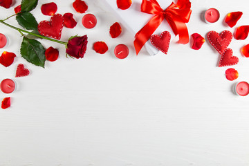 Gift with red ribbon, red rose and heart on a white background. The concept for Valentine's Day, a romantic gift to a loved one for the holiday.