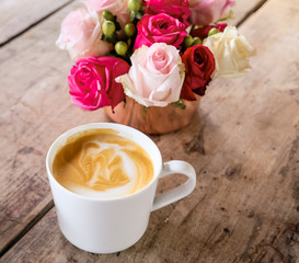 Cup of coffee latte and flowers.