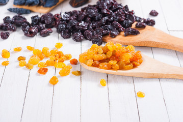 dried goji, cherry, raisin and plum fruits on white wood
