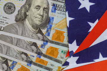 Dollars bills, cash pile and United States flag