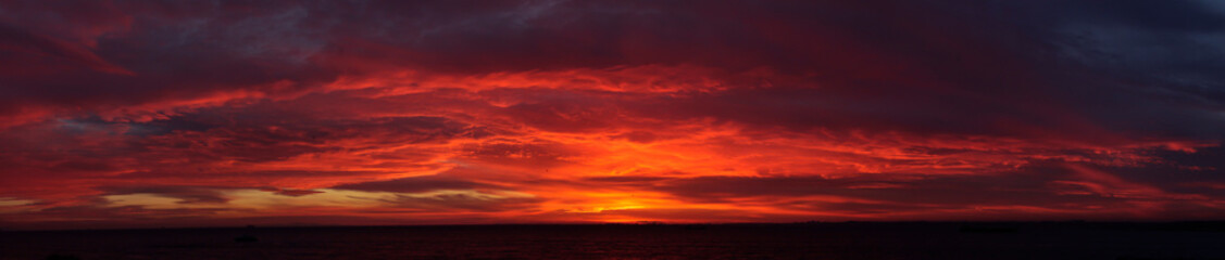 Naklejka na ściany i meble Amazing sky at Sunset red clouds skyline, panoramic photo