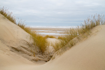 View on beach and North sea between two dunes 