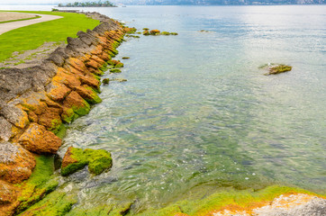 Walkpath along beautiful peaceful lake Garda, Italy