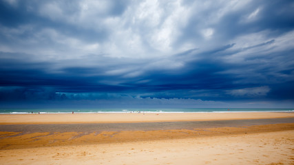 Strandimpression in Lacanau Océan, Frankreich, bei aufziehenden, dunklen Gewitterwolken