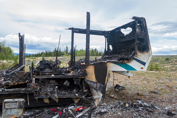 The front of a burned out trailer by the side of the road