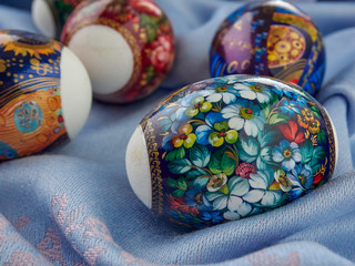 A colorful Easter egg lies on the surface of the fabric.Easter colored bright eggs