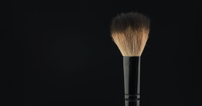 Rotation of a cosmetic brush on a black background.