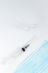 Medical mask with ear straps on white background. Medical tools for health professionals.Disposable syringe