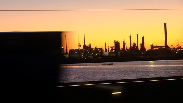 The skyline of the industrial area of ​​Porto Marghera at sunset seen from the train