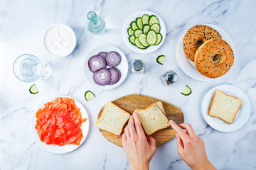 Marble table with ingredients for making bagel or sandwich for lunch