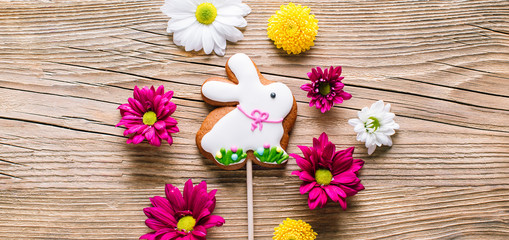 Easter cookies on wooden background, gingerbread in the shape of a rabbit