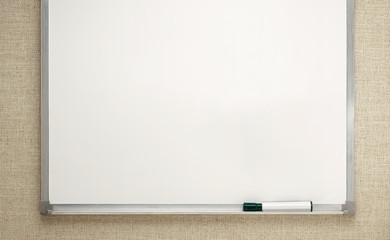 empty white board on wall with black marker on tray