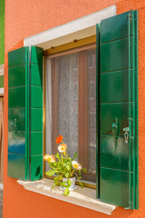 Beautiful window decorated with flowers in Italy