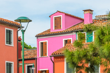 Fototapeta na wymiar Colorful apartment building with nice waterfront view in Burano, Venice, Italy.