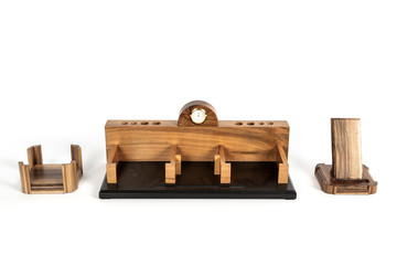 Decorative table wooden watches with pen holes and a place for papers on an isolated background.