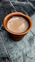 A kulhar or kulhad cup (traditional handle-less clay cup) from North India filled with hot Indian tea