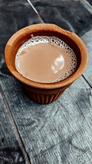 A kulhar or kulhad cup (traditional handle-less clay cup) from North India filled with hot Indian tea