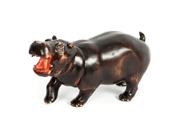 wooden figure of a hippopotamus isolated on background.