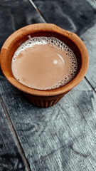 A kulhar or kulhad cup (traditional handle-less clay cup) from North India filled with hot Indian tea