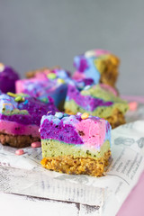 Raw vegan colorful cheesecake (cashew cake) on a piece of paper. Dessert made with Filipino superfood yam or ube. Healthy lifestyle and raw vegan dessert concept. 