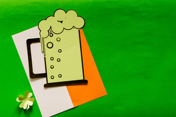 Saint Patrick's day background, flag, clover leaves, beer glass, hat.