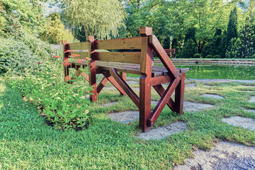 Retro style wooden bank in the backyard garden