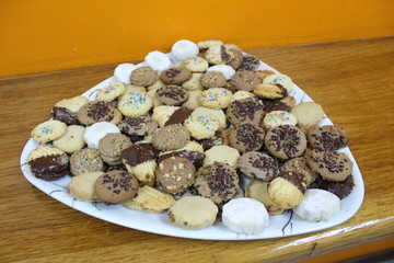 Many sweet cookies on a white plate