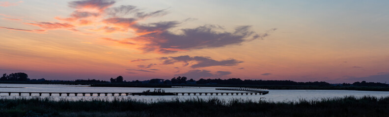 sunset over the lake in an panorama setting