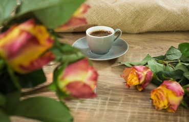 Fototapeta na wymiar Fresh italian style coffee next to flower bouquet