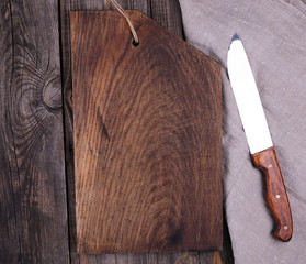 very old empty wooden rectangular cutting board and knife, top view