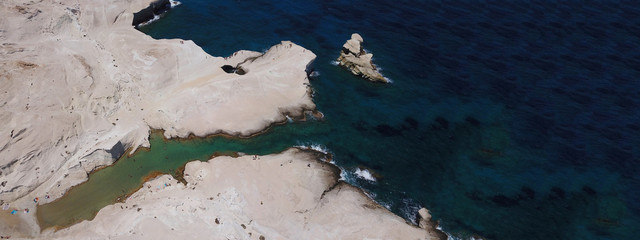 Aerial drone ultra wide photo of beautiful white chalk volcanic rocky beach of Sarakiniko, Milos island, Cyclades, Greece