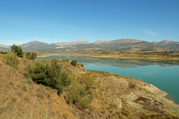 Panorama view of the man-made reservoir Lake Vinuela in the stunning landscape of the Axarquia, Malaga province, Spain, Europe