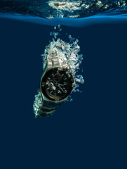 Watch under water on a blue background