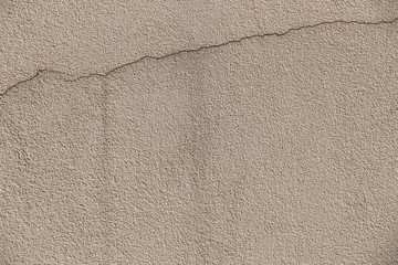 Cracked textured concrete surface with water stain - beige and grunge background