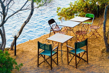 Table with chairs at Mediterranean sea Sardinia reflex
