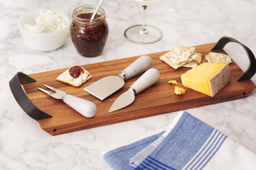 cheese board with jelly on wood and marble