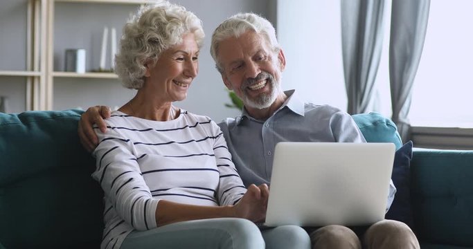 Serious middle aged man explaining new computer software to wife.