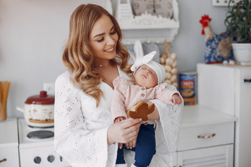 Cute newborn with mother. Family at home. Mother with daughter in a room