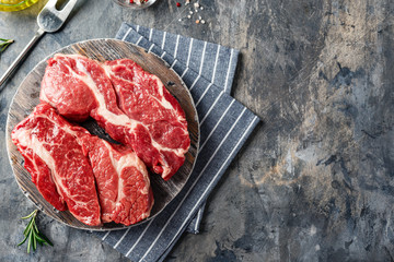Raw beef steak on dark gray background