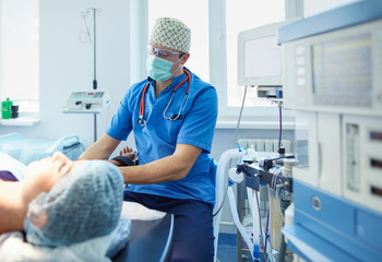 Man surgeon at work in operating room