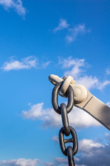 Oahu, Hawaii, USA. - January 10, 2012: Pearl Harbor. Chain detail of USS Arizona anchor on display as statue under blue cloudscape. 