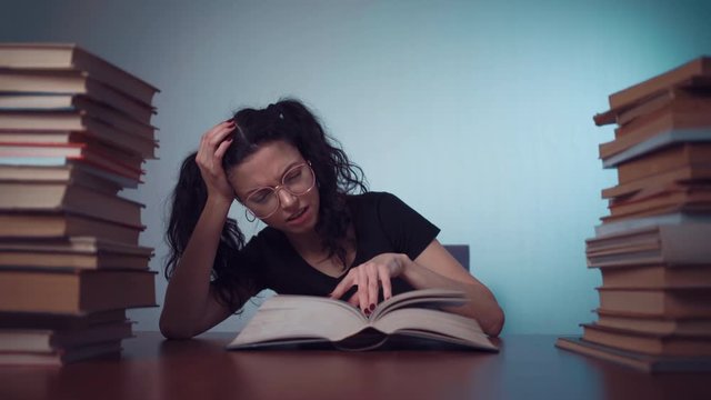 young girl bored and tired of reading book at home