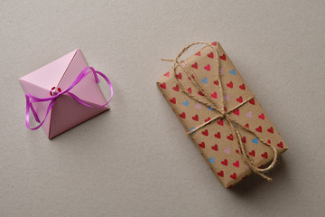 Valentine's day gift boxes on a cardboard beige background with space for your creativity and space for text.